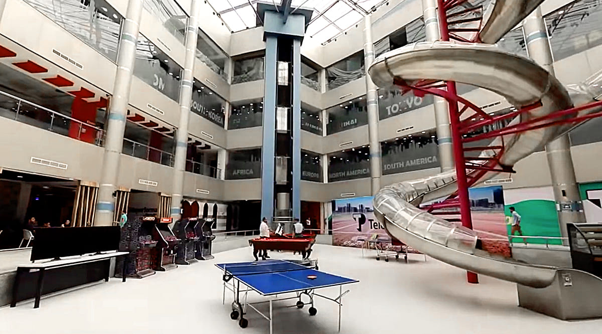 Modern facilities at TP in Africa featuring a ping-pong table and a giant slide